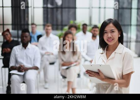 Selective focus of lecturer talking to audience during seminar in conference room Stock Photo
