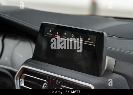 Modern car media display in the interior of the car. Touchscreen monitor on the dashboard of the modern car. Stock Photo