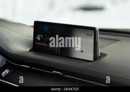 Modern car media display in the interior of the car. Touchscreen monitor on the dashboard of the modern car. Stock Photo