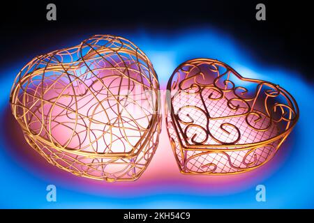 Metal Heart-Shaped Boxes on Blue Background Stock Photo