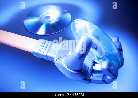 Robotic Hand with CD on Blue Background Stock Photo