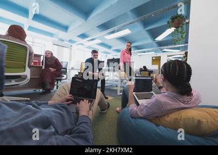 Collaborative process of multicultural skilled young business team during brainstorming meeting in office.Diverse group of young people dressed in Stock Photo