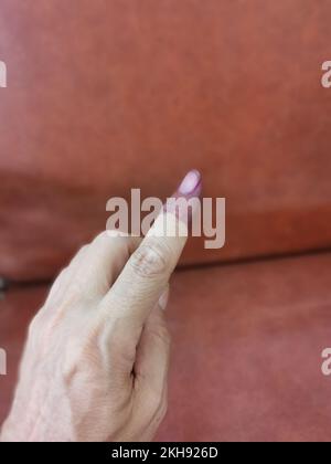 electoral purple ink stain mark on the index finger Stock Photo