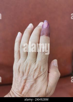 electoral purple ink stain mark on the index finger Stock Photo