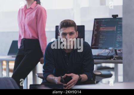 Programming. Man Working On Computer In IT Office, Sitting At Desk Writing Codes. Programmer Typing Data Code, Working On Project In Software Stock Photo