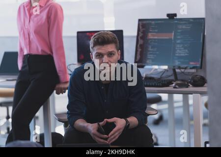Programming. Man Working On Computer In IT Office, Sitting At Desk Writing Codes. Programmer Typing Data Code, Working On Project In Software Stock Photo