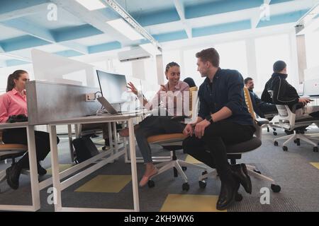 Collaborative process of multicultural skilled young business team during brainstorming meeting in office.Diverse group of young people dressed in Stock Photo