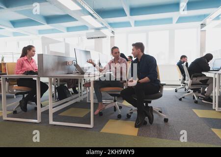 Collaborative process of multicultural skilled young business team during brainstorming meeting in office.Diverse group of young people dressed in Stock Photo