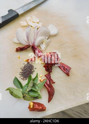 herbs and spices, common flavoring ingredients for asian and south asian cuisine, for cooking on white cutting board, selective focus with copy space Stock Photo