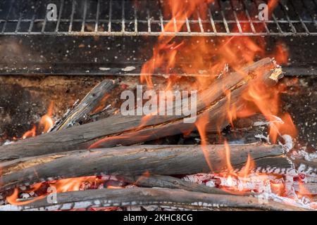 In grill of barbecue grill, ash embers of fire have been left over after bonfire burns firewood ready for barbecue cooking Stock Photo