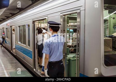 Signals Train Japan Trainman signals engineer to depart subway Station in Tokyo, Japan ...