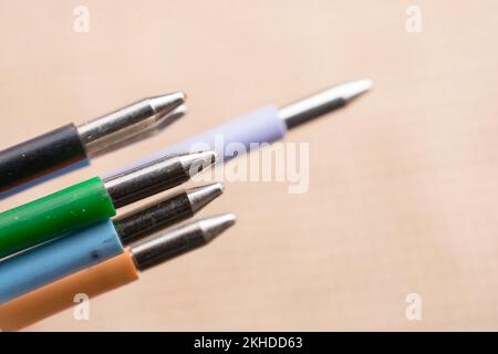 Multi colored pen on a textured background on display Stock Photo