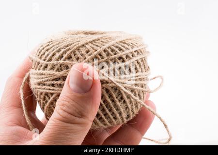 Spools of thread in hand isolated on a white background Stock Photo
