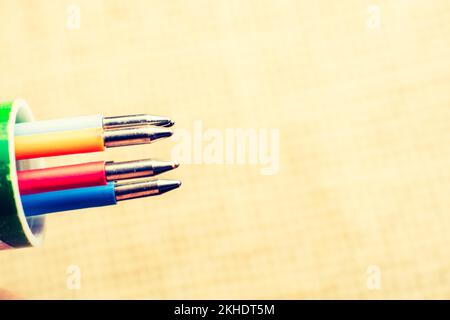 Multi colored pen on a textured background on display Stock Photo