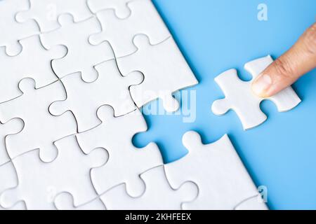 Jigsaw puzzle with missing piece. Completing final task, missing jigsaw puzzle pieces and business concept with a puzzle piece missing. Stock Photo