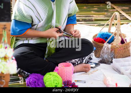 Karen ethnic working embroidery knitting yarn lanna style in handmade craft shop in oh poi local market bazaar for thai people and foreign travelers t Stock Photo