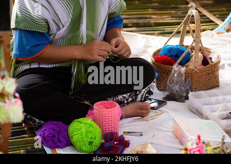 Karen ethnic working embroidery knitting yarn lanna style in handmade craft shop in oh poi local market bazaar for thai people and foreign travelers t Stock Photo