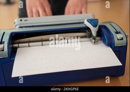 Blind man using braille typewriter.  Stock Photo