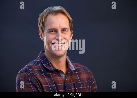Smiling always lightens up his day. A cropped studio portrait of a handsome man. Stock Photo