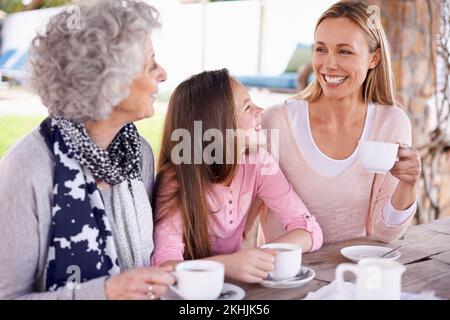 These girls love their tea. three generations of the woman of the women of a family having tea outside. Stock Photo