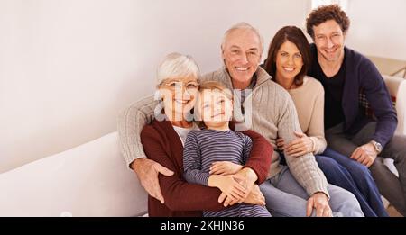 Family is everything. A cropped portrait of a happy multi-generation family sitting together on a sofa. Stock Photo