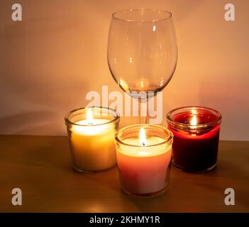 photo of an empty glass and lit candles Stock Photo