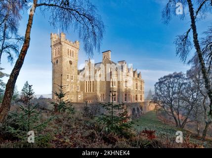 Carbisdale Castle Invershin Scotland a blue sky over the building and garden in early winter Stock Photo