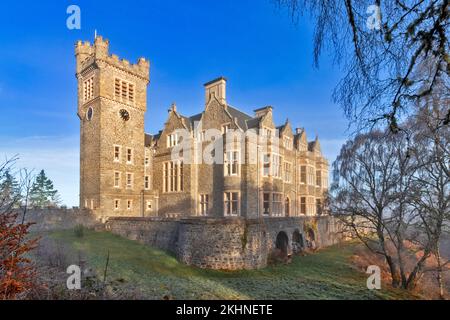 Carbisdale Castle Invershin Scotland blue sky and an early morning mist over the building and garden Stock Photo