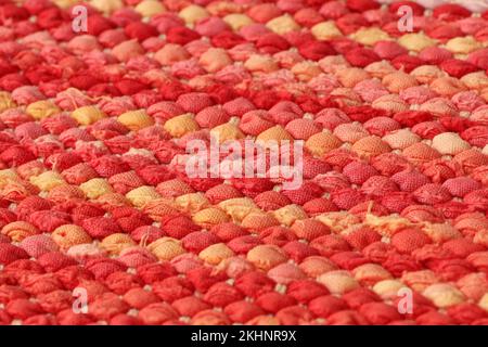 Closeup of colorful rag rug in red and orange colors. Stock Photo