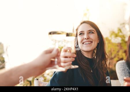 Wine, happy and woman toast in celebration at a party with friends in outdoor restaurant on holiday. Smile, cheers and girl drinking champagne Stock Photo