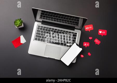 Laptop, smartphone with likes from social networks, credit card on the desktop. View from above. High quality photo Stock Photo