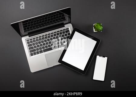 Laptop, tablet, smartphone with a place for your inscription on the desktop. View from above. High quality photo Stock Photo