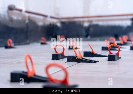 close-up of the tile alignment system holding tile in given position Stock Photo