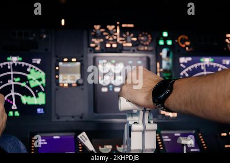 Aircraft captain in cockpit command taking off with airplane, throttling power engine lever Stock Photo