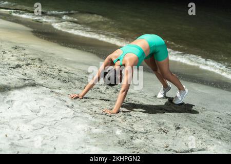Black Sportswoman Doing Push Ups On Beach Stock Photo