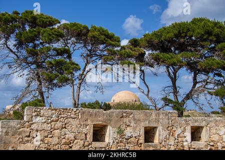 The view through the trees on the dome of Sultan Ibrahim Han in the Fortezza fortress ruins in Rethymno Stock Photo