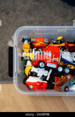 A vertical top view of a toy model Mack truck on its side on a pile of toys Stock Photo