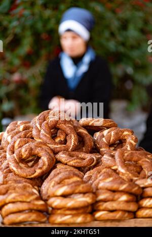 Freshly baked Turkish Simit, a sesame seed bagel type bread roll sold from street carts, a traditional staple cuisine usually eaten for breakfast with Stock Photo