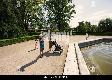 Mother with kids near fountain of Slavkov Castle, also known as Austerlitz Castle, is a Baroque palace in Slavkov u Brna, Czech Republic Stock Photo