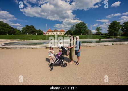 Mother with kids near fountain of Slavkov Castle, also known as Austerlitz Castle, is a Baroque palace in Slavkov u Brna, Czech Republic Stock Photo