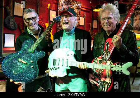 24 November 2022, Hamburg: Guitar maker Jens Ritter (l-r), comedian and musician Otto Waalkes and Uli Salm, celebrity host and rock musician, stand on stage with Ritter's guitars at the Zwick St. Pauli. Guitar maker Jens Ritter presents some of his instruments at the cult pub 'Zwick' on St. Pauli. Ritter's electric guitars and electric basses are not only purchased by musicians, but also by collectors and museums; his instruments can also be seen at the Metropolitan Museum of Art (New York) at the Smithsonian American Art Museum (Washington, D.C.) and at the Technoseum (Mannheim). Photo: Marcu Stock Photo