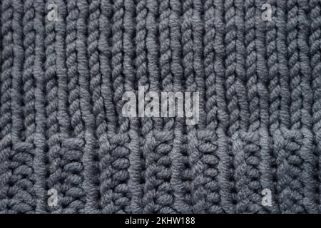 Knitted grey background, gray sweater cozy pattern. Stock Photo