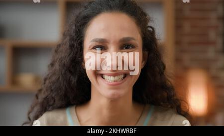 Closeup happy cheerful carefree delight glad female face 30s Hispanic Latino Caucasian smiling toothy dental lady client of dentistry service house Stock Photo