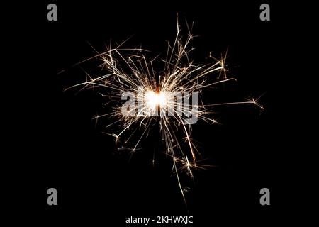 Burning sparkler isolated on black background. Fireworks theme. Light effect and texture. Christmas and new year decoration. Stock Photo