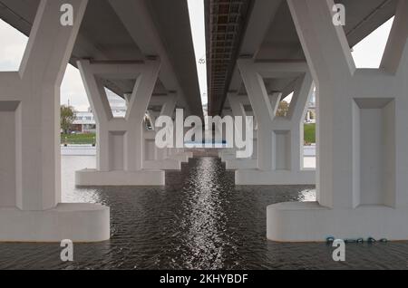 Bottom view of the concrete bridge over the river Stock Photo