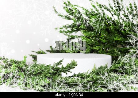 Creative christmas layout empty podium or pedestal display on white background with cylinder stand concept, with spruce christmas wreath, in the rays Stock Photo