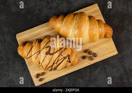 Two fresh croissants on a dark background. Copy space, top view Stock Photo