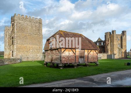 The Cowdray House Ruins in Cowdray Park, Midhurst, West Sussex, England, UK, during November, with medieval granary building Stock Photo