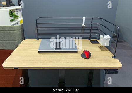 Closed Laptop Notebook Computer With Wireless Mice at Small Wooden Desk Workplace Stock Photo