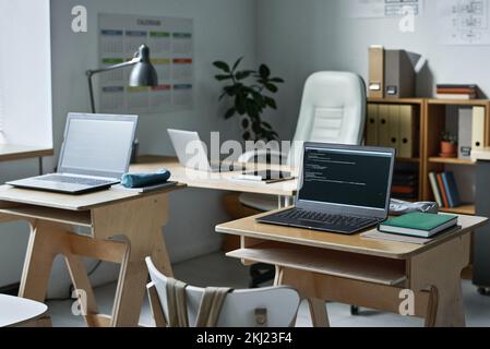Modern empty class with desks and computers for studying information technology Stock Photo